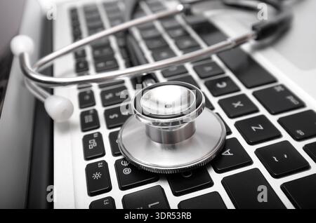 doctor's stethoscope on laptop computer keyboard Stock Photo