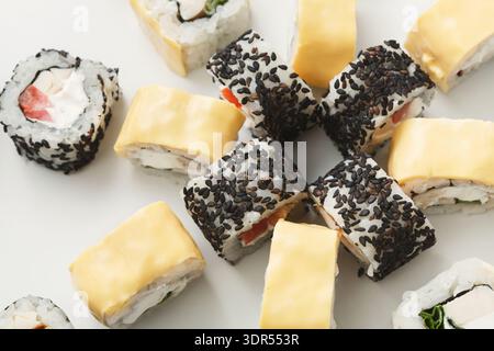 Different Types of Sushi Rolls Arranged in a Circular Pattern on a White Surface Stock Photo