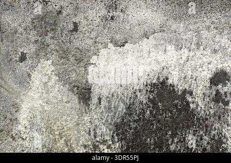 Old grey wall with weathered surface. Abstract patterns on the wall Stock Photo