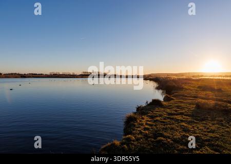 Winter sunset over West Langney Lake in Eastbourne, East Sussex, UK Stock Photo