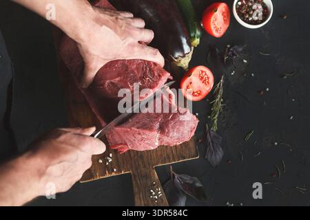 Meat Preparation in Kitchen With Fresh Vegetables and Herbs Involved in Cooking Process Stock Photo