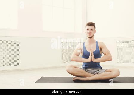 Young Man Practicing Yoga in a Bright Indoor Space Stock Photo