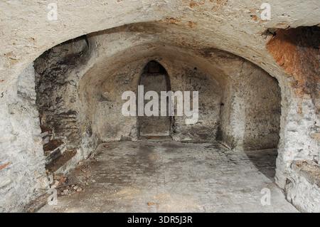 The 14th-century medieval undercroft beneath Strangers’ Hall in Norwich, Norfolk. This vaulted stone structure served as a secure storage area for the wealthy merchant owners of the house, which is now a museum of domestic life. The brick and stone vaulting provided a fireproof foundation for the Great Hall above, reflecting the architectural sophistication of the city's prosperous textile and trading classes. Stock Photo