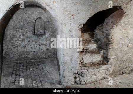 The 14th-century medieval undercroft beneath Strangers’ Hall in Norwich, Norfolk. This vaulted stone structure served as a secure storage area for the wealthy merchant owners of the house, which is now a museum of domestic life. The brick and stone vaulting provided a fireproof foundation for the Great Hall above, reflecting the architectural sophistication of the city's prosperous textile and trading classes. Stock Photo