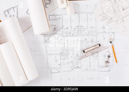 Collection of Architectural Plans, Sketches, and Tools on a Workspace Top Stock Photo
