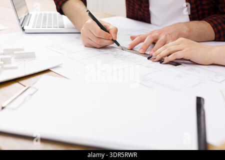 Planning a Construction Project at a Workspace With Design Documents and Tools on the Table Stock Photo