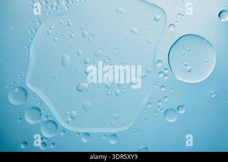 Close up view of water and oil creating an abstract blue texture Stock Photo
