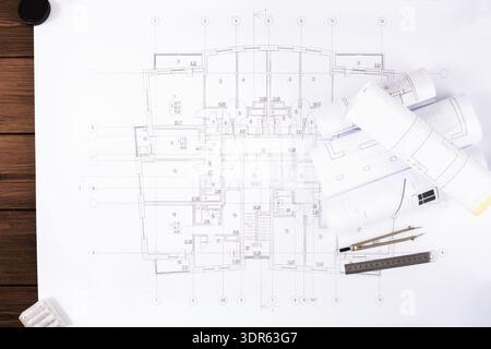 Collection of Architectural Plans and Design Documents on Workplace Desk Stock Photo