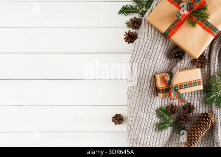 Collection of Holiday Gifts Arranged With Pinecones and Greenery on a Soft Knit Surface Stock Photo
