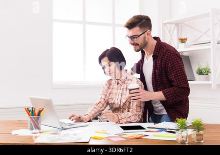 Young Professionals Working Together in an Office During the Day in a Modern Workspace Stock Photo