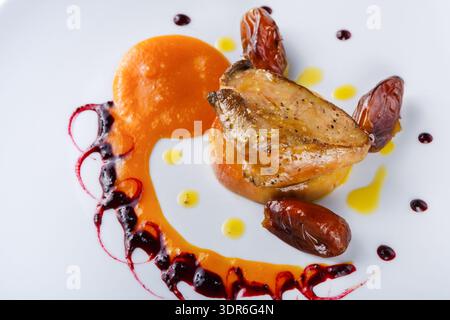 Pork Dish With Sauce and Garnish Served on a Clean White Plate in a Bright Setting Stock Photo