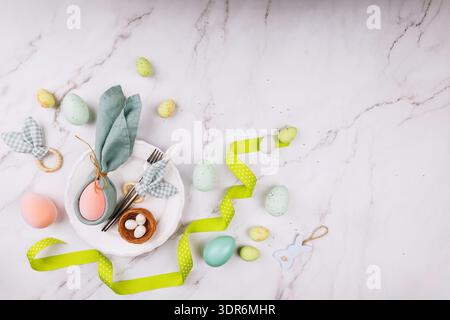Top View of Easter Decor with Plate and Bunny Napkin.. Stock Photo