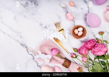 Easter Celebration Setting with Roses and Eggs. Stock Photo