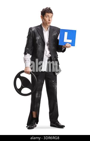 Confused driver in a torn suit holding a steering wheel and a learner sign isolated on white background Stock Photo