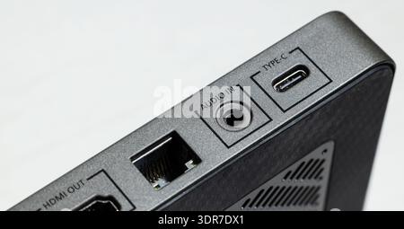 Detailed view of the side panel of a sleek electronic device showcasing various connectivity options like USB Type-C, audio input jack, and HDMI outpu Stock Photo
