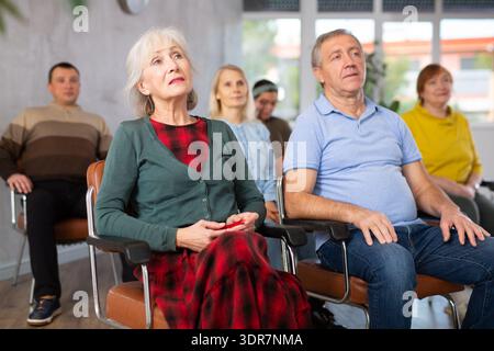Group of mature students attending lecture in college Stock Photo