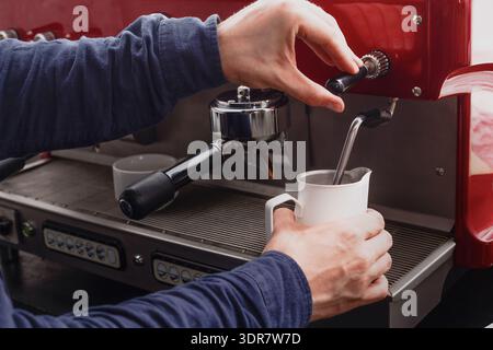 Coffee Preparation Process in a Cafe Using an Espresso Machine With Milk Steaming Stock Photo