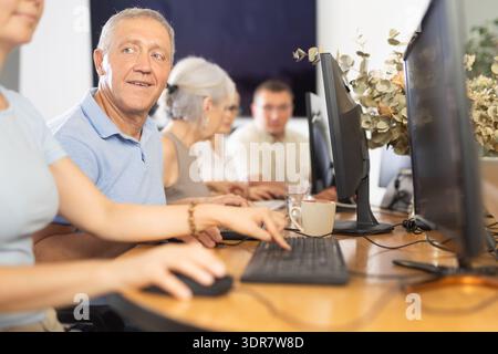 Group of older people studying on computer course Stock Photo