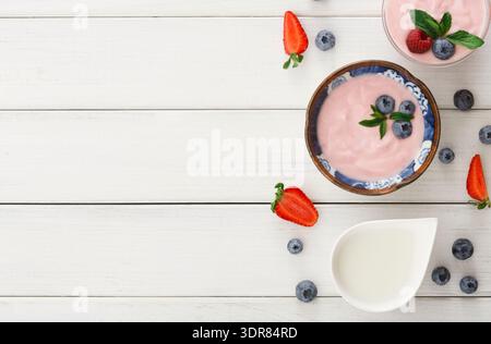 Fruit and Yogurt Collection on a Table With Fresh Berries and Mint Leaves Stock Photo