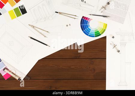 Collection of Design Drawings, Colors, and Tools Arranged on a Wooden Surface Stock Photo