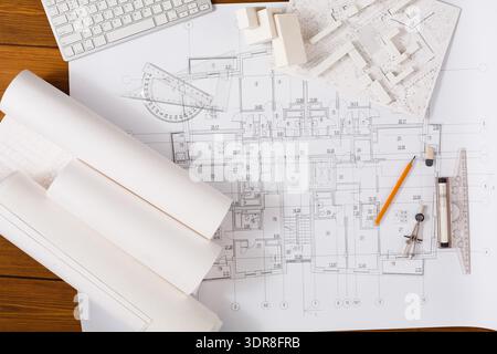 Blueprint Layout Shows Details for a Building Project and Design Plans With Tools on Wooden Table Stock Photo