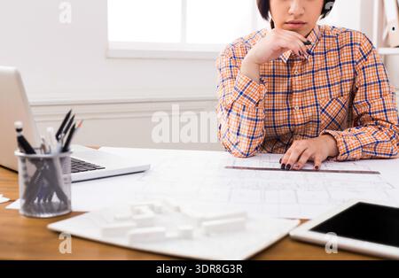 Student Works on Architectural Project With Plans and Models in Workspace During Daytime Stock Photo