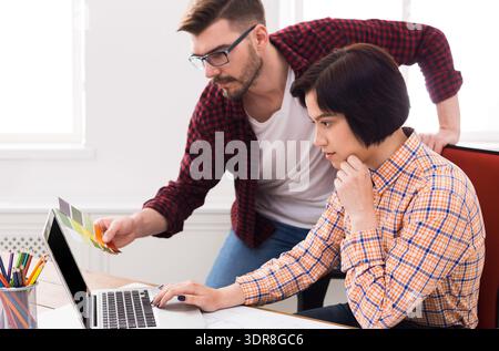 Two People Working Together on a Project in a Bright Office Space Stock Photo