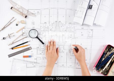 Collection of Design Tools and Blueprints on Table During Architectural Planning Session Stock Photo