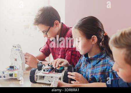 Students Build and Program Robots During a Workshop in a Classroom in the Afternoon Stock Photo