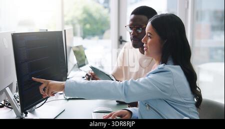 People, software developer and conversation in office with computer, tablet or advice for web design. Digital designer, team and point in workplace Stock Photo