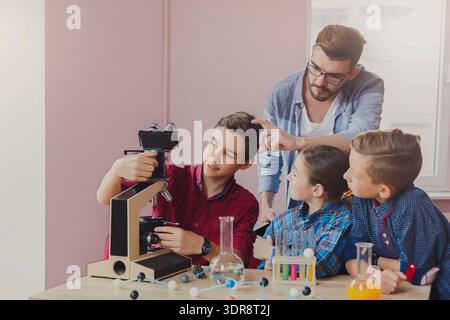 Students Learn About Microscopes During a Science Class in a Bright Classroom Setting Stock Photo