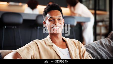 Happy, portrait and man on couch, relax and confident on break in living room, home and comfortable. Lounge, chilling and person with smile on weekend Stock Photo