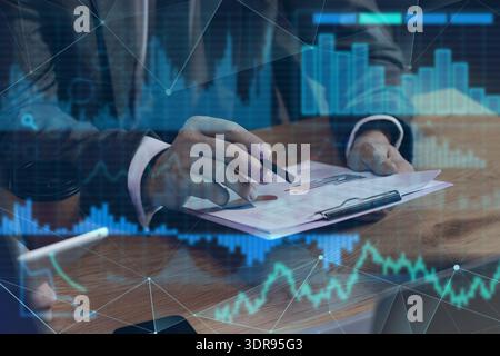 Double exposure of male business analyst working in office and virtual screen with diagrams Stock Photo