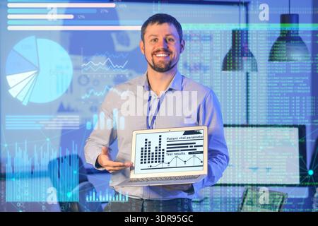 Double exposure of virtual screen with diagrams and male business analyst with laptop in office Stock Photo