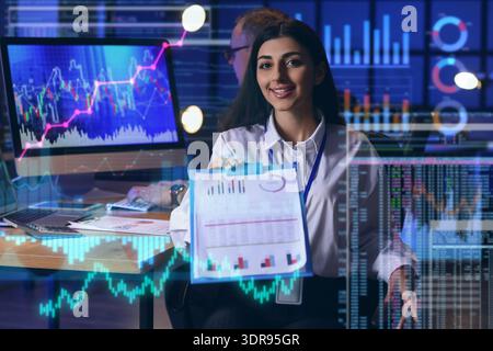 Double exposure of virtual screen with diagrams and female business analyst in office Stock Photo
