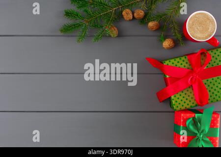 Collection of Gift Boxes, Nuts, and Coffee Cup on Gray Wooden Table With Green Leaves Stock Photo