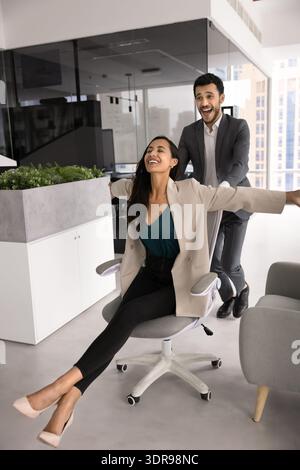 Two happy workmates having fun in coworking office Stock Photo