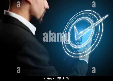 Man using digital interface to confirm banking invoice payment in a modern setting Stock Photo