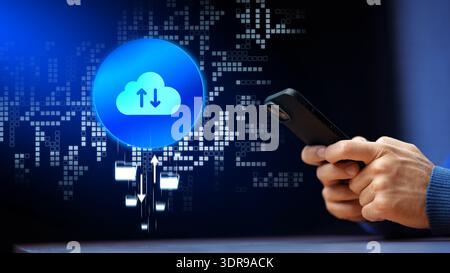 Using a smartphone to upload data to the cloud at night with digital graphics in the background Stock Photo