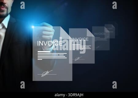 Businessman preparing banking invoice payment with digital documents in office setting Stock Photo