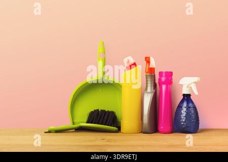 Collection of Cleaning Supplies Arranged on a Table With a Simple Background Stock Photo