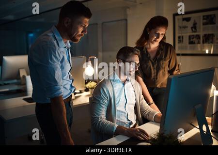 Night, business people or brainstorming with computer in office, prototype deadline or software upgrade. Planning, discussion or developer team with Stock Photo
