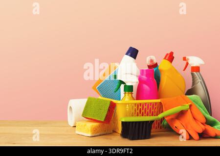 Collection of Cleaning Supplies in a Set Arranged on a Wooden Table Against a Soft Background Stock Photo