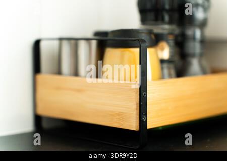 A close-up of a kitchen spice rack with beautiful depth of field focused on the object. Assorted spice jars neatly arranged on a wooden stand, showcas Stock Photo