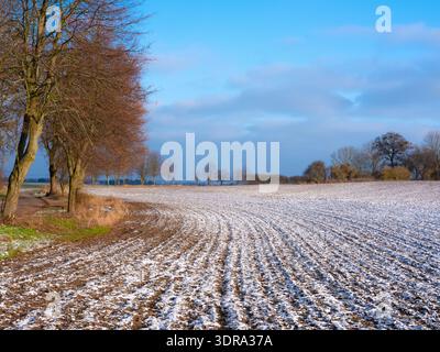 The melting of the snow on the fields in early spring. White nature background Stock Photo
