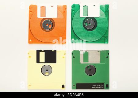 Collection of Colorful Floppy Disks Arranged in a Grid on a White Background Stock Photo