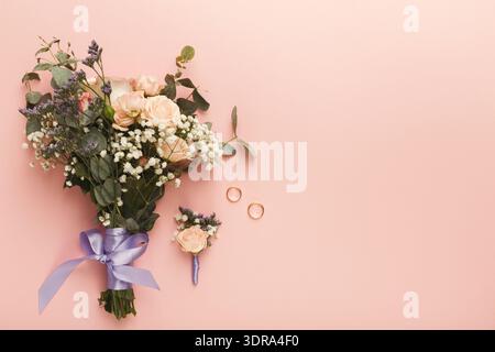 Collection of Wedding Flowers and Rings on Pink Background for Special Occasion Stock Photo