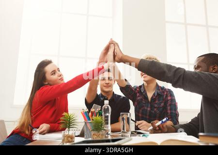 Group of Students Interacting During a Study Session in a Bright Room Stock Photo