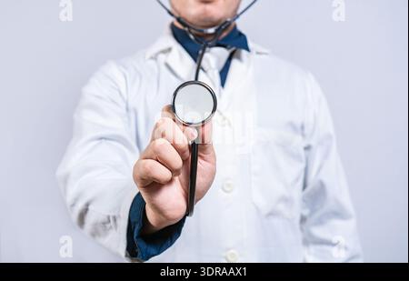 Close up of doctor showing stethoscope medical isolated. Unrecognizable doctor holding a stethoscope Stock Photo