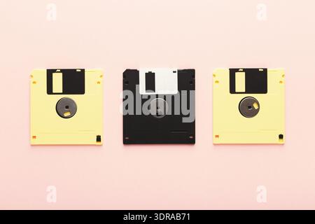 Collection of Vintage Floppy Disks Arranged in a Collage on a Pink Surface Stock Photo